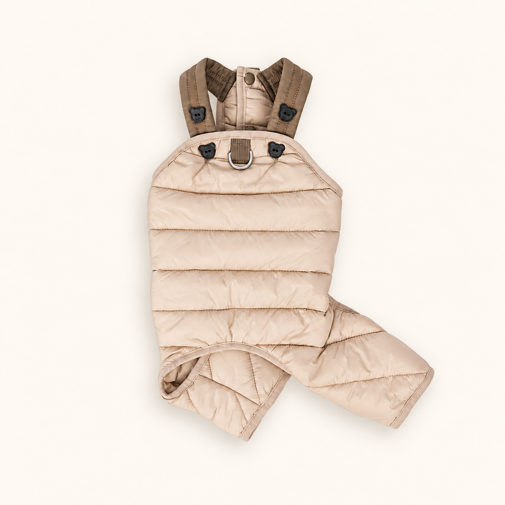 Khaki quilted dog jumpsuit with brown shoulder straps and bear buttons on a cream background