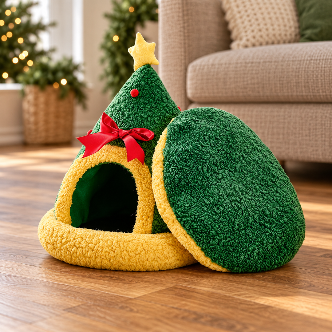 Green tree-shaped pet bed with yellow trim, top star, red bow and matching separate round cushion in a warm home.
