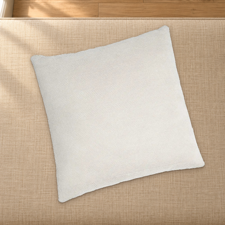 Beige herringbone chenille pillow styling reference resting on a fabric-covered bench