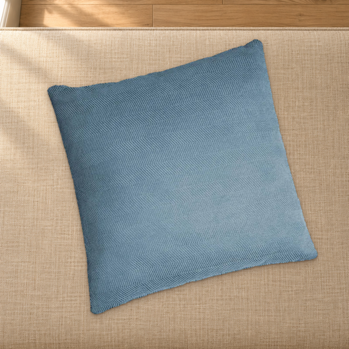 Lake Blue herringbone chenille pillow styling reference resting on a fabric-covered bench