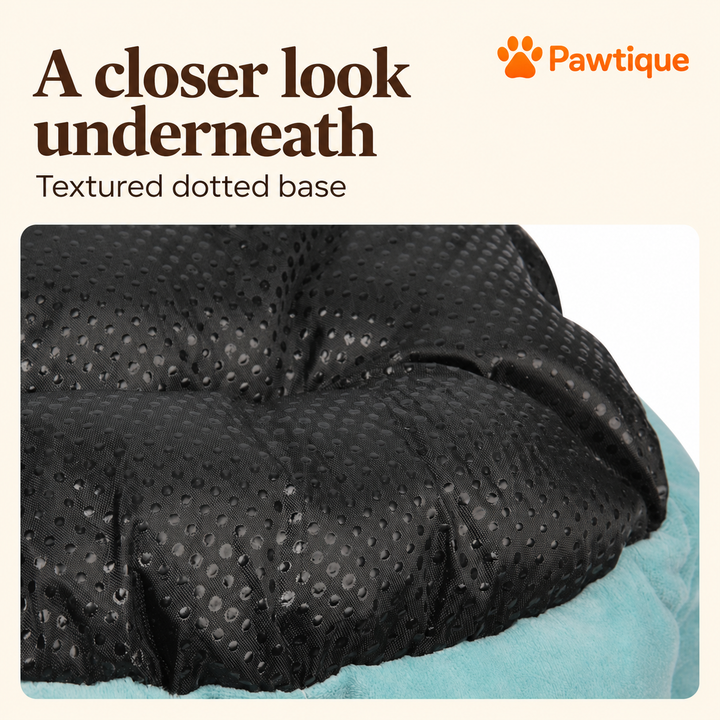 Dinosaur pet bed close-up of black dotted underside fabric and teal edge.