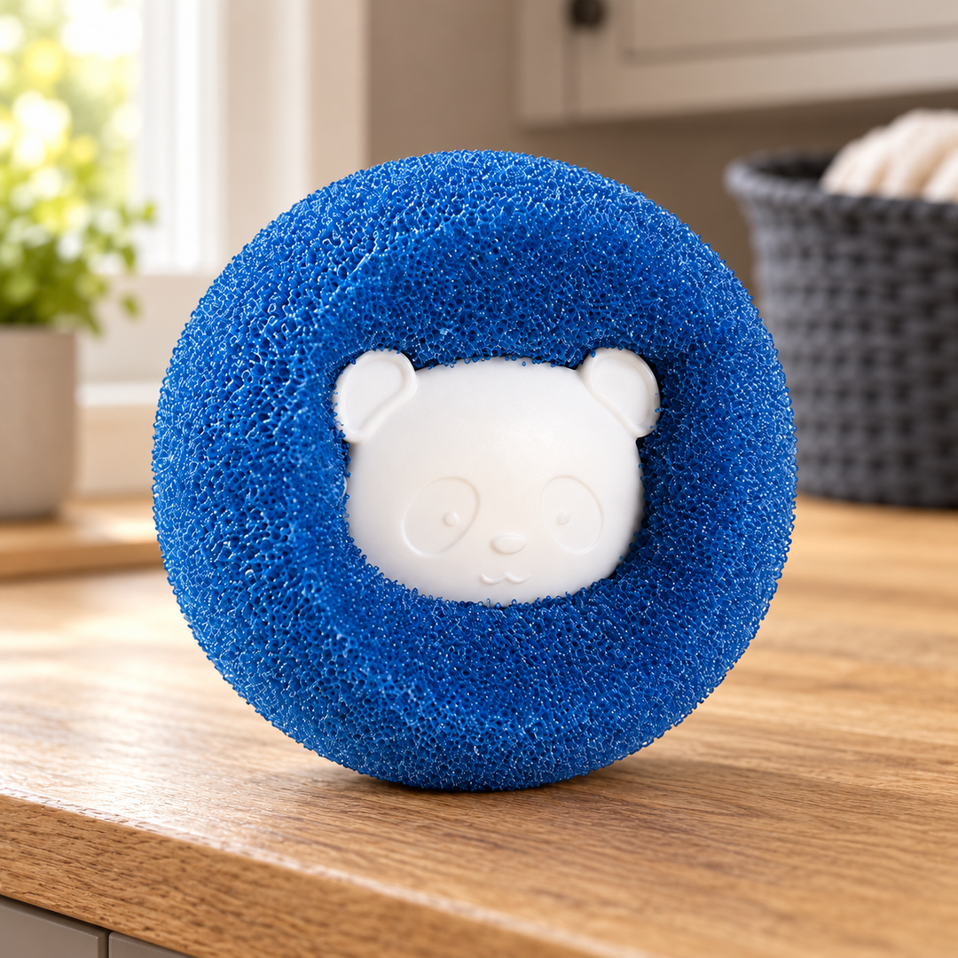One blue round laundry fur catcher with its original pale bear-face centre on an oak laundry counter.