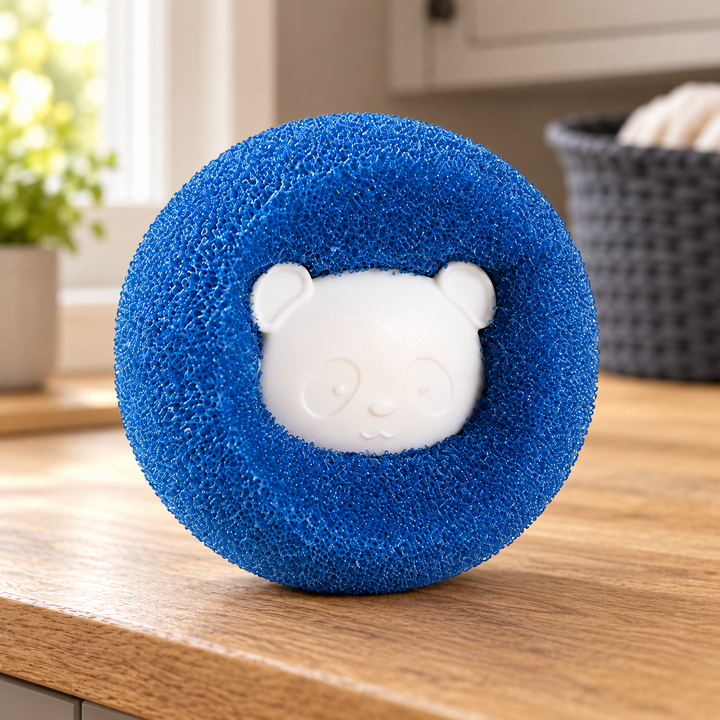 One blue round laundry fur catcher with its original pale bear-face centre on an oak laundry counter.