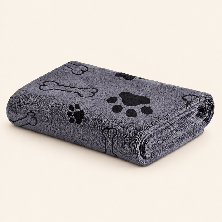 Grey Pawtique Bone and Paw microfiber pet towel folded on a warm cream background