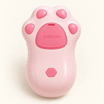 Pink paw-shaped rechargeable grooming brush with petspa marking and a small scalloped control button.