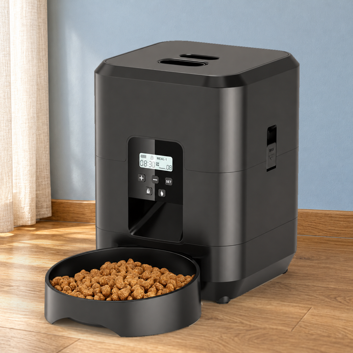 Black button-control feeder with original LCD, five buttons and matching food bowl in a naturally lit home setting.