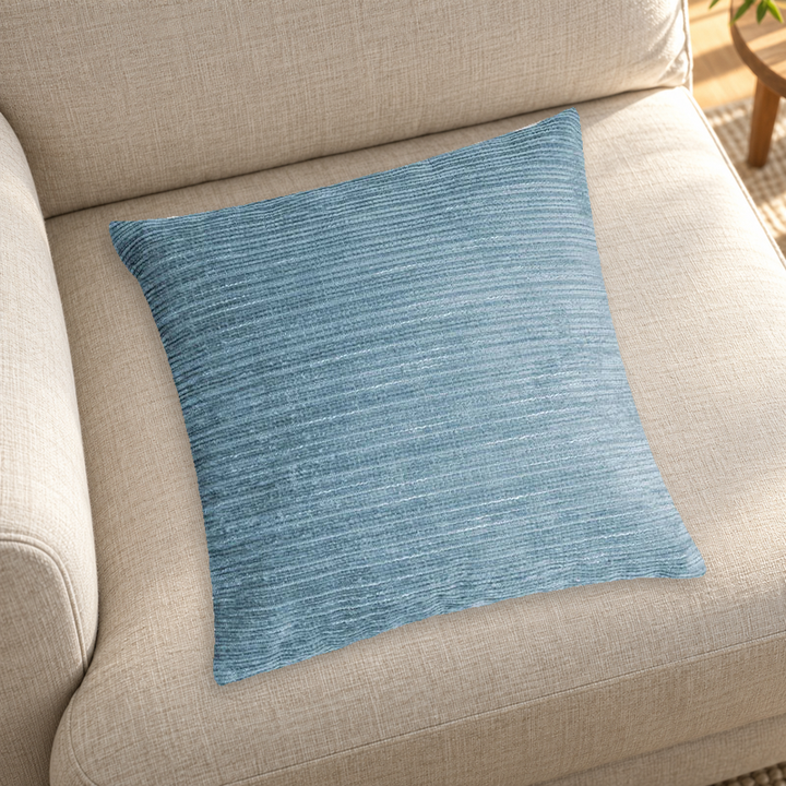 Blue striped chenille pillow color reference on a neutral sofa; insert inclusion is not specified