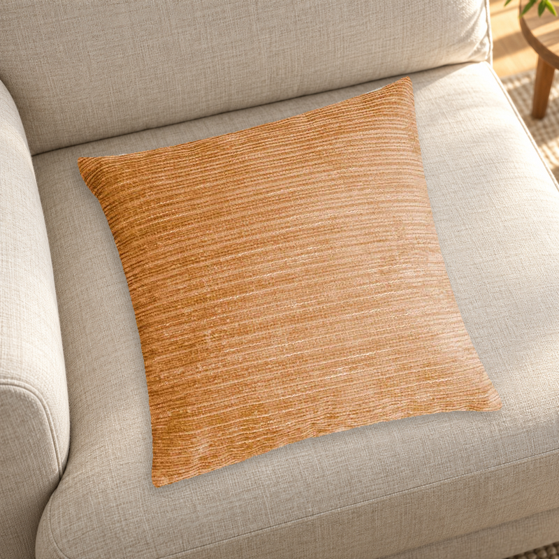 Orange striped chenille pillow color reference on a neutral sofa; insert inclusion is not specified