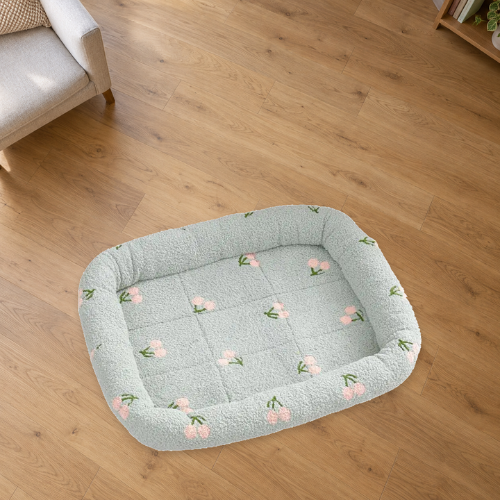 Green Cherry Print pet bed with pale pink cherries and a quilted center