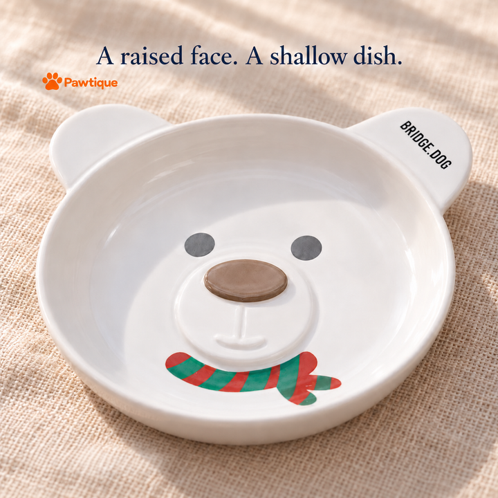 White ceramic bear bowl showing the shallow rim, raised muzzle, brown nose and authentic BRIDGE.DOG lettering on the ear.