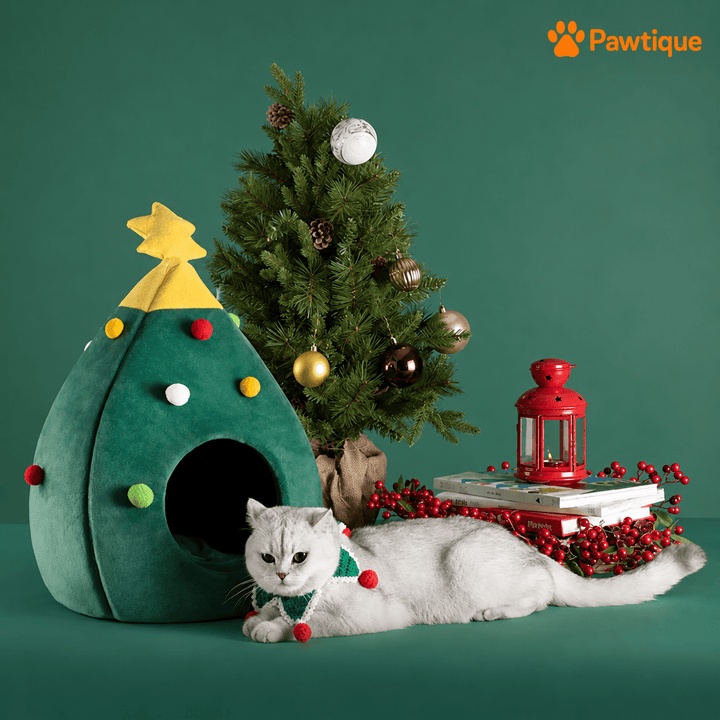 Green Christmas Tree Pet Cave in a festive setting with a cat resting beside the entrance.