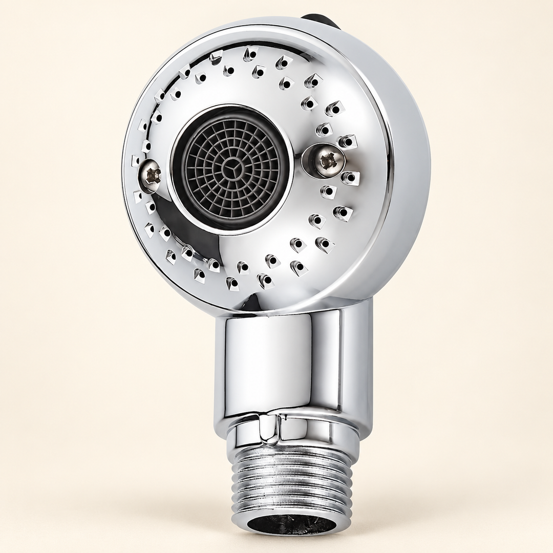 Compact silver pet shower attachment with outer spray nozzles, central mesh outlet, black top toggle and threaded connector on a warm ivory background.