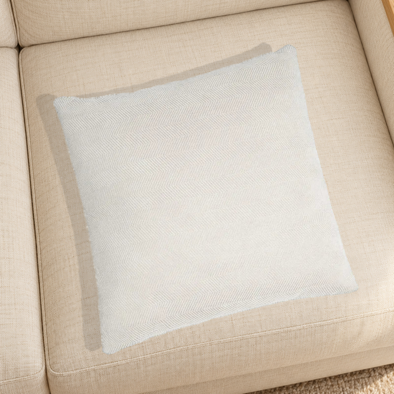Beige herringbone chenille pillow resting on a linen chair in a home setting; one selected-color pillow option.