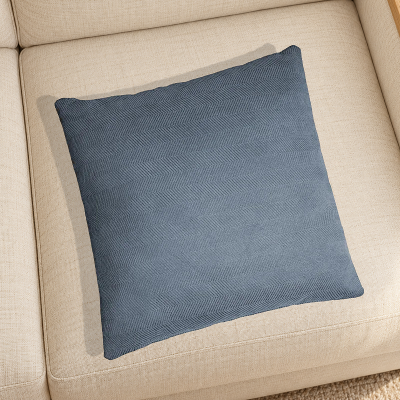 Greyish Blue herringbone chenille pillow resting on a linen chair in a home setting; one selected-color pillow option.