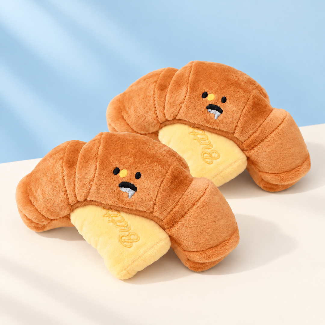 Two ButterCroissant plush dog toys with butter pieces on a clean backdrop