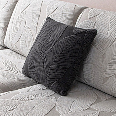 EverLeaf dark grey leaf-patterned pillow shown on a sofa; styling props are not the selected option contents.