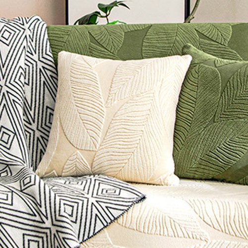 EverLeaf white leaf-patterned pillow shown on a sofa; styling props are not the selected option contents.