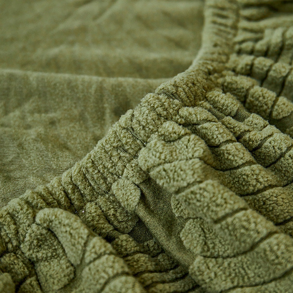 Close view of original green leaf-patterned fabric and elastic edge.