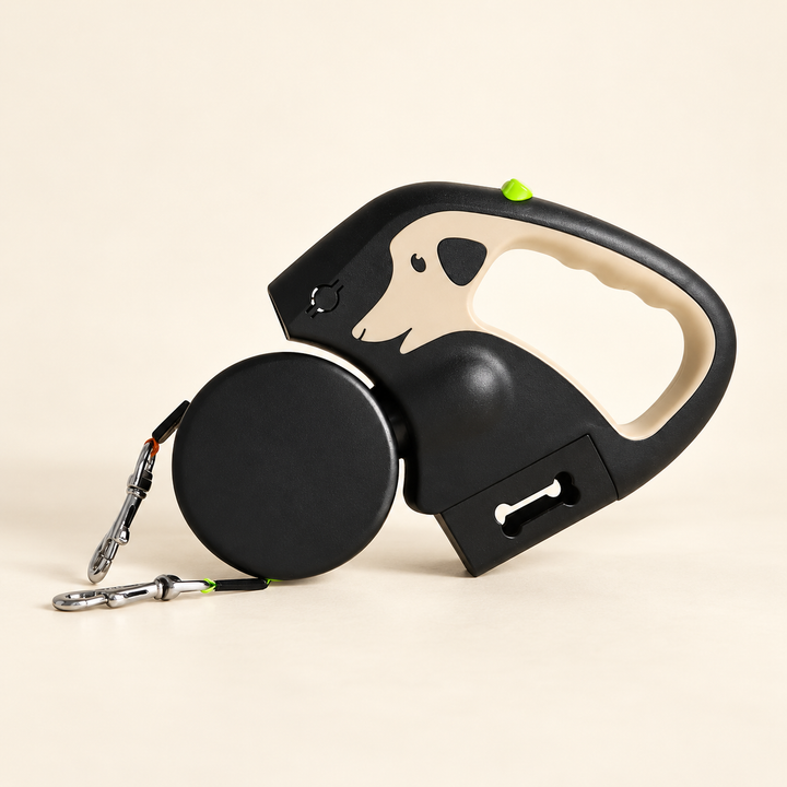 Khaki and black dual retractable dog leash with dog-shaped grip, two metal clips and waste-bag compartment on cream background