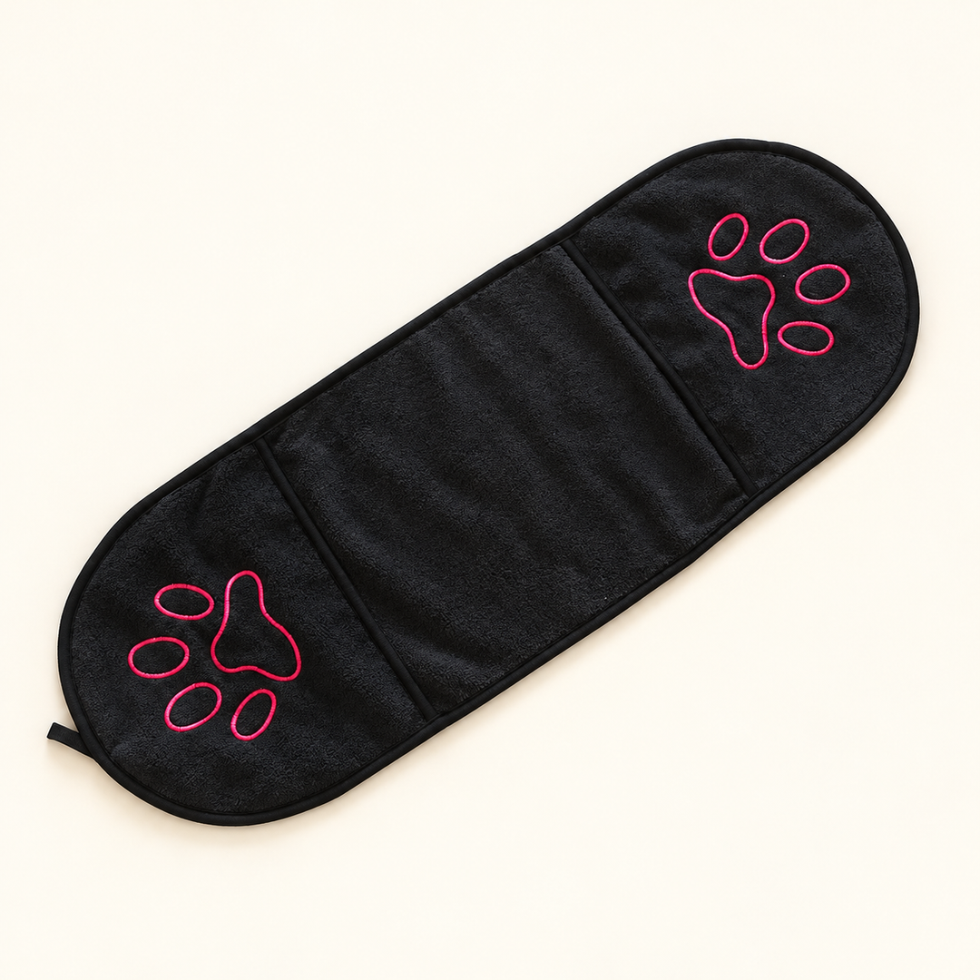 Black pet drying towel laid flat with two hand pockets and pink paw embroidery