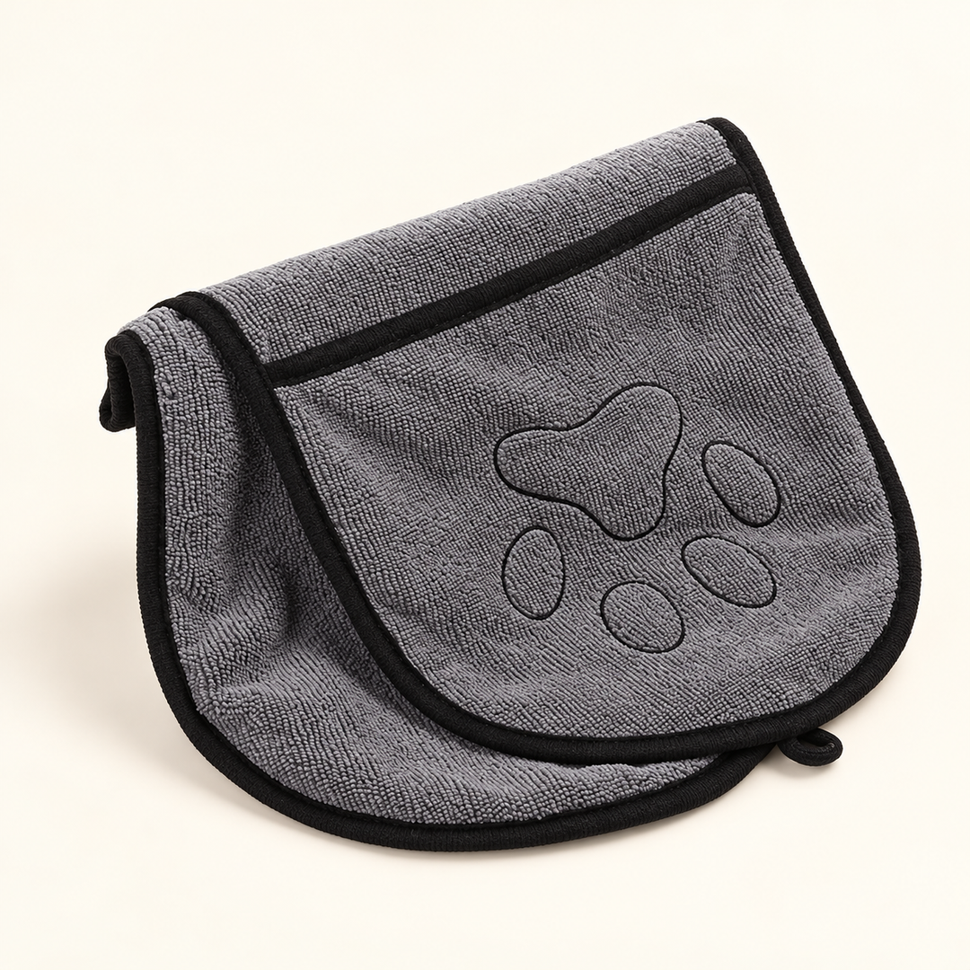 Gray microfiber pet drying towel folded to show its hand pocket and black paw embroidery