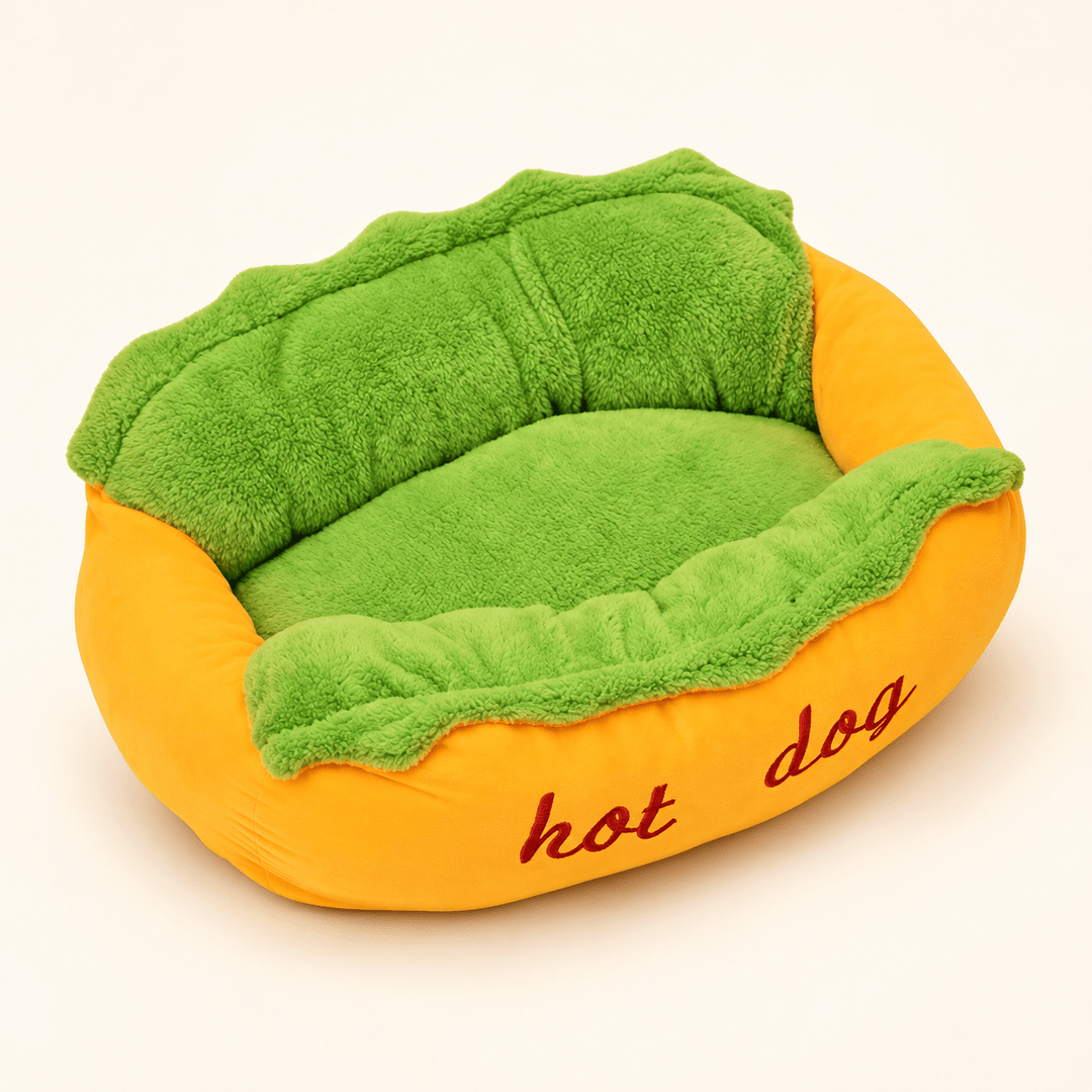 Hot Dog Bolster Dog Bed with a yellow bun-shaped surround, green plush center and red hot dog embroidery.