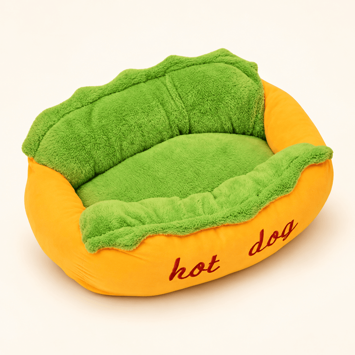 Hot Dog Bolster Dog Bed with a yellow bun-shaped surround, green plush center and red hot dog embroidery.