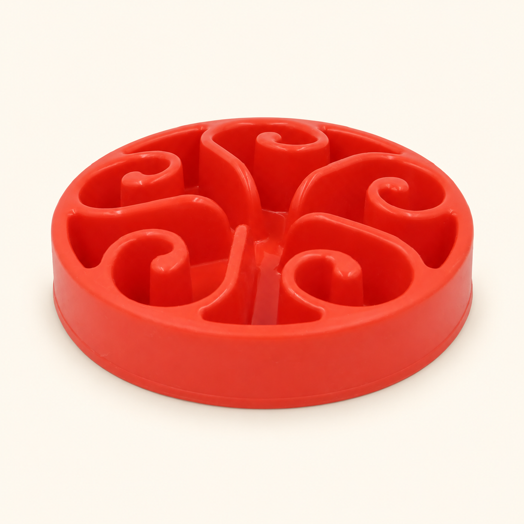 Red slow-feeder dog bowl with raised spiral channels