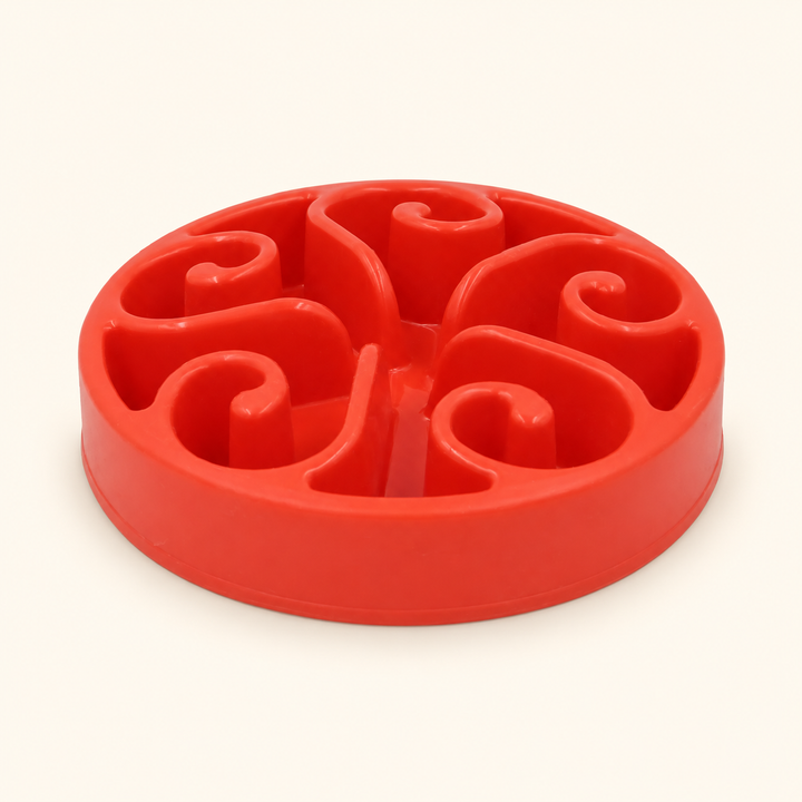 Red slow-feeder dog bowl with raised spiral channels
