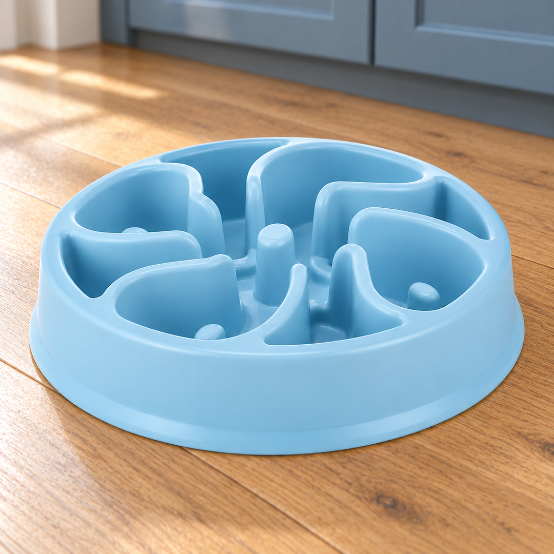 Sky Blue slow-feeder dog bowl with broad curved divider walls and distinct raised posts on a natural wood kitchen floor.