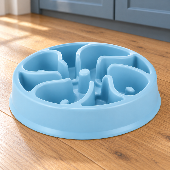 Sky Blue slow-feeder dog bowl with broad curved divider walls and distinct raised posts on a natural wood kitchen floor.