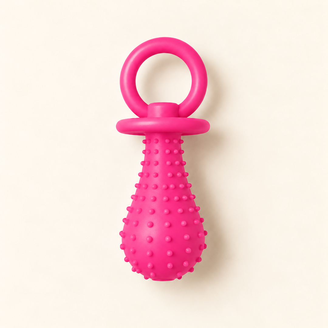 Pawtique PaciPlay TPR pacifier dog toy in pink, Large, on a warm cream background.