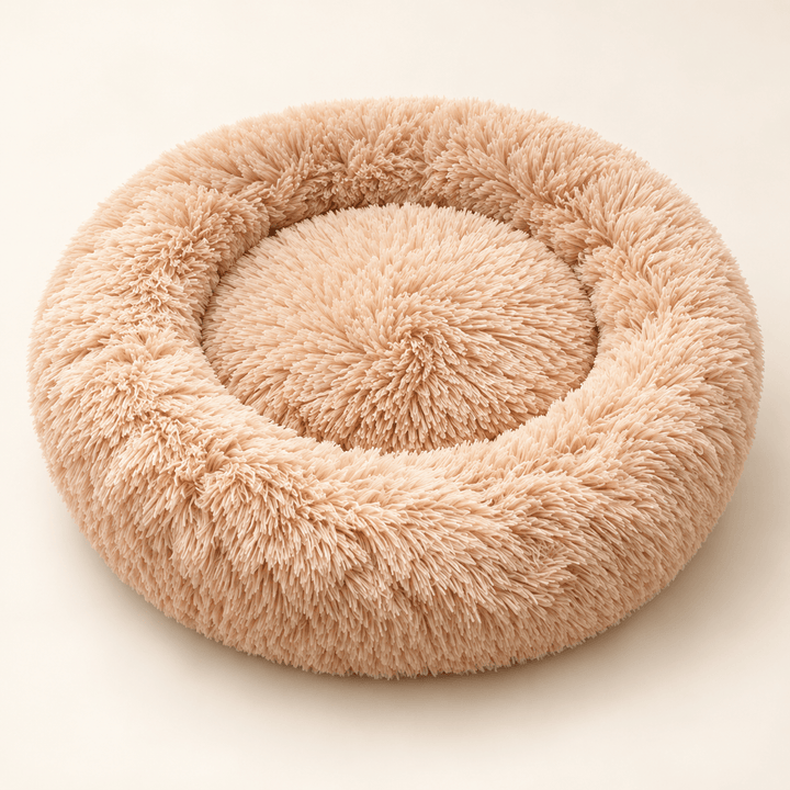 Beige Plush Donut Cuddler bed with a raised plush rim and recessed round center.