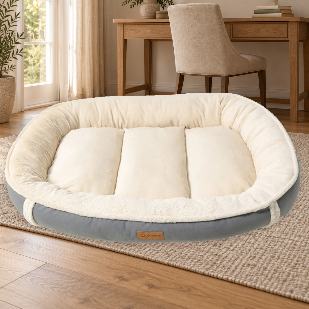 Gray bolster dog bed with cream plush-textured rim and segmented center