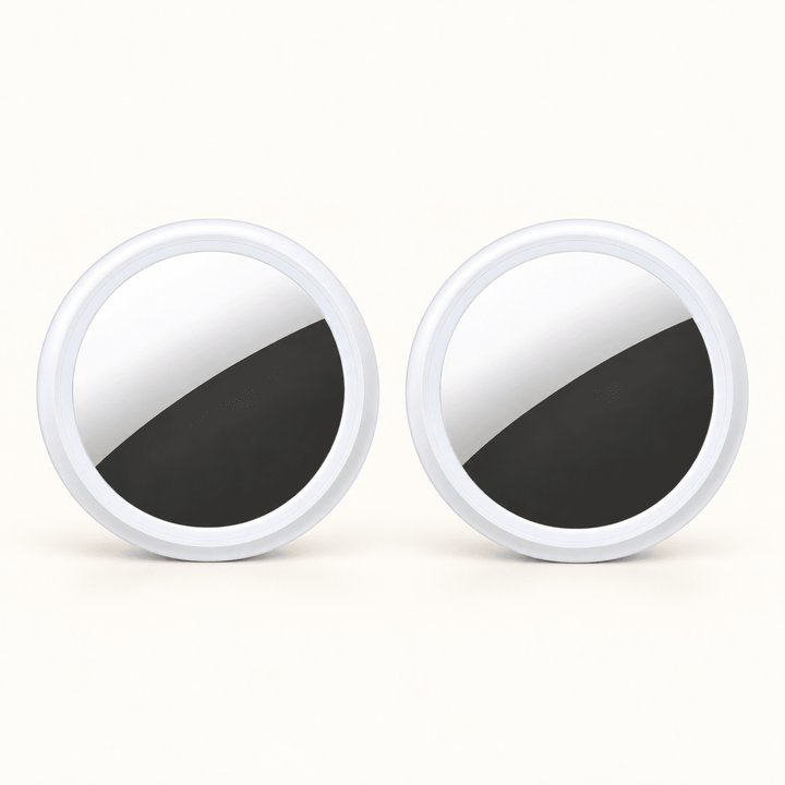 Two white circular S10 Bluetooth item finders on a warm cream background