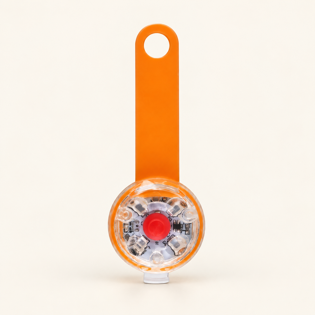 Orange rechargeable LED collar light, flexible strap with clear round lamp and red center button