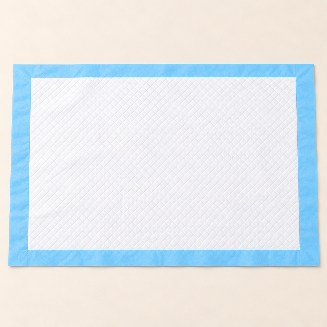 Wide rectangular disposable training pad with white quilted surface and flat blue border